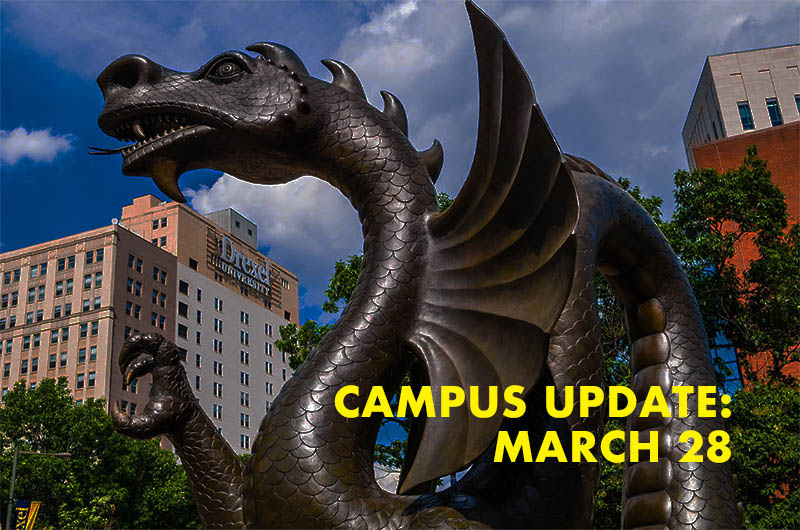 Dragon statue with the words campus update March 28